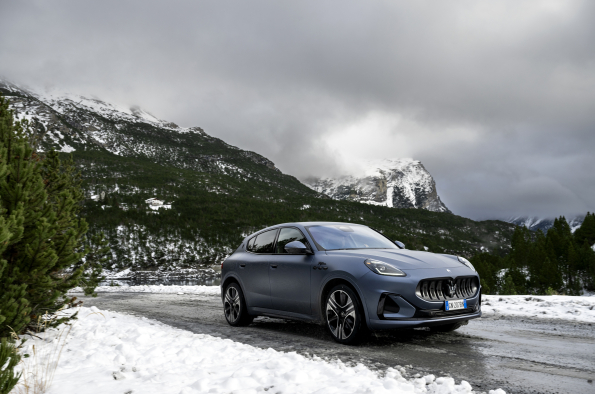 A 2025 Maserati Grecale Folgore drives through the mountains.