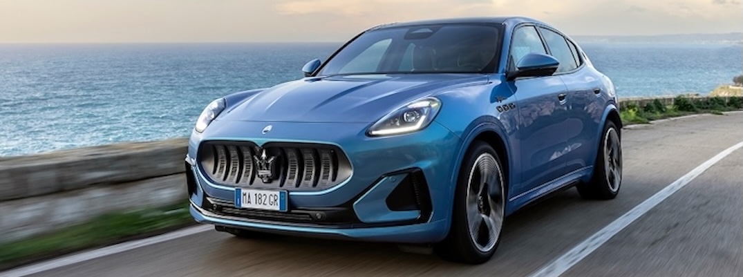 A blue 2025 Maserati Grecale drives by the waterfront.