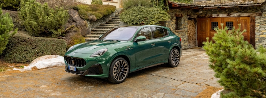 A green 2025 Maserati Grecale Trofeo sits in front of a cabin.